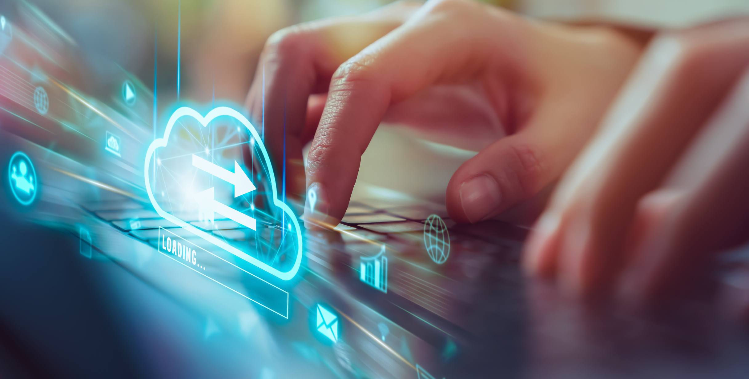 Hand using laptop with continuous data protection uploading data.